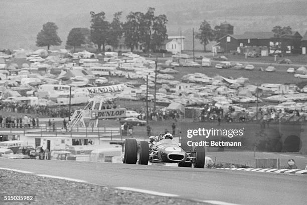 Watkins Glen, NY: Current world champion Jack Brabham breaks over the hill at the Watkins Glen Grand Prix race course during a practice round here....