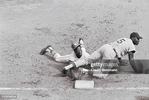 St. Louis, Missouri: Lou Brock's helmet falls off as Cards' speedster hustles back to 1st on pick off try in 6th inning of 3rd game of World Series....