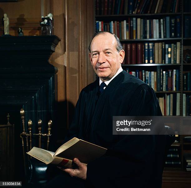 Supreme Court Associate Justice Abe Fortas wearing his robes in his office.