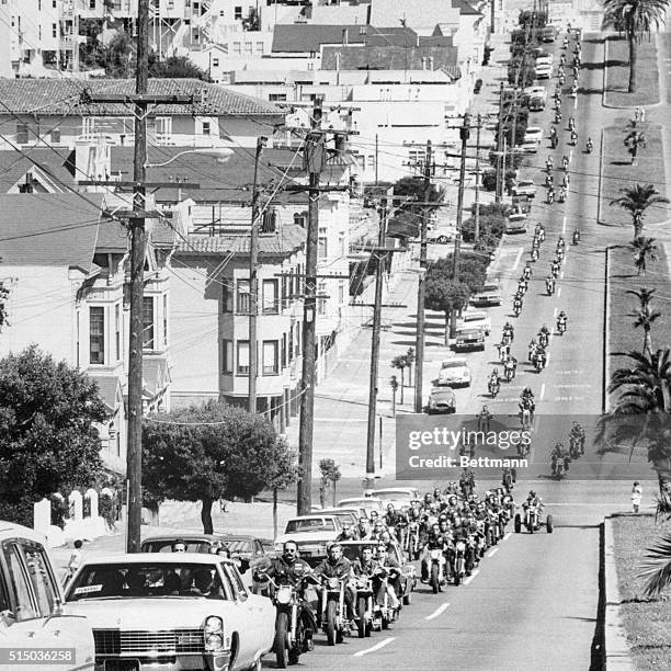 San Francisco, California: Hell's Angels-style funeral cortege dots a hilly street as upwards of 200 cyclists roared to funeral party for one of...