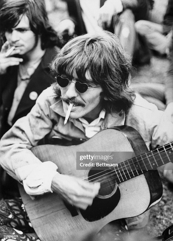 George Har The Beatles lead guitar player George Harrison strums a borrowed ...