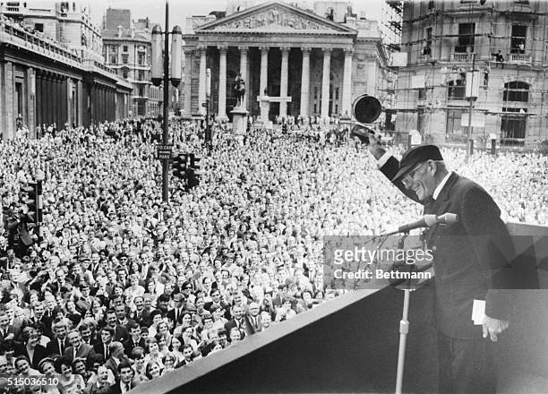Solo around the world yachtsman Sir Francis Chichester waves to huge crowd from balcony of the mansion House here on July 7th. In his hand,...