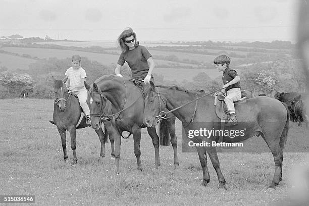 Jacqueline Kennedy, widow of John F. Kennedy, rides horses with their children Caroline and John Jr. During a family vacation in Ireland. Caroline...