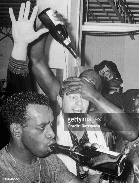 Boston, Massachusetts: Red Sox slugger Carl Yastremski is doused with champagne by teammate George Scott after Boston defeated the Twins to win the...