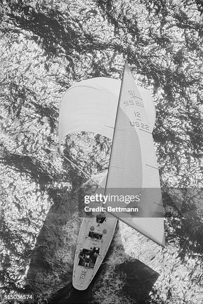 Newport: Intrepid, America's Cup defender, her skipper bus Mosbacher at the helm. Sails smoothly over the course with spinnaker full, to defeat...