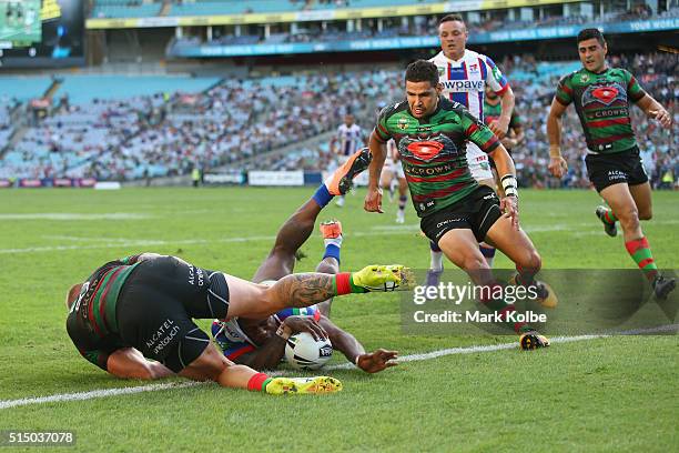 Aaron Gray of the Rabbitohs tackles Akuila Uate of the Knights as he scores a try only to have it disallowed on review during the round two NRL match...