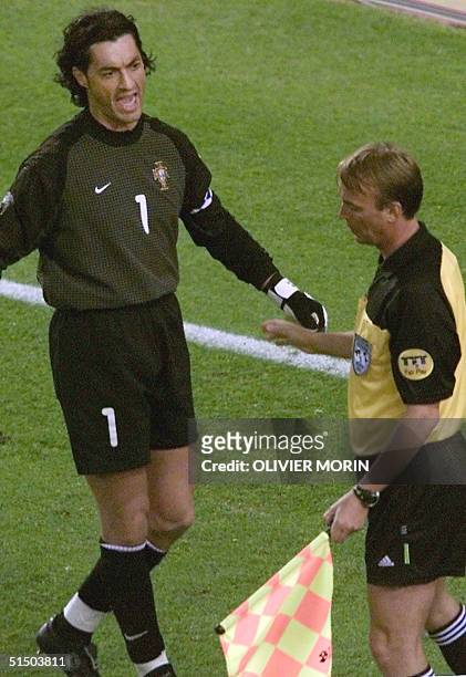 Portuguese goalkeeper and captain Vitor Baia argues with the assistant referee, Slovak Igor Sramka, during the Euro-2000 semi-final match between...