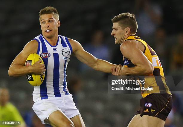 Luke Breust of the Hawks tackles Andrew Swallow of the Kangaroos during the NAB CHallenge AFL match between the Hawthorn Hawks and the North...