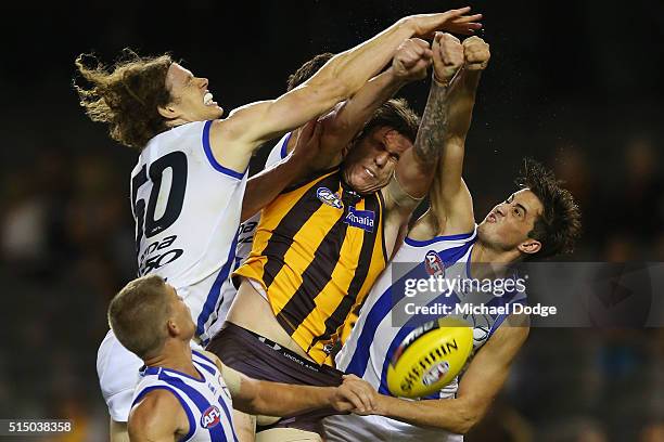 Kaiden Brand of the Hawks competes for the ball against Ben Brown and Taylor Garner of the Kangaroos during the NAB CHallenge AFL match between the...