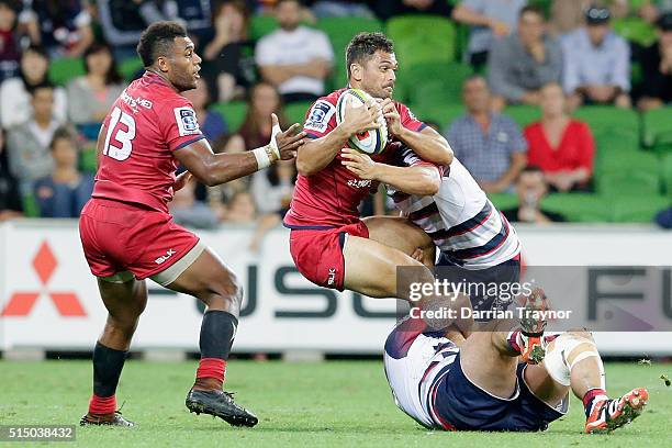 Karmichael Hunt of the Reds is tackled during the round three Super Rugby match between the Rebels and the Reds at AAMI Park on March 12, 2016 in...