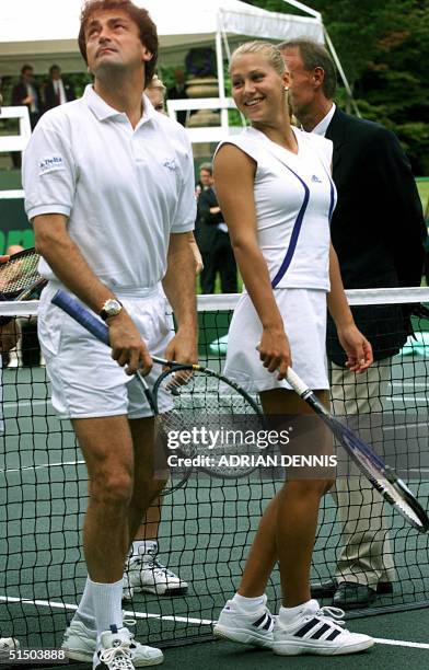 French Henri Leconte jokes around with Russian Anna Kournikova while being introduced at a charity tennis match in the gardens of Buckingham Palace...