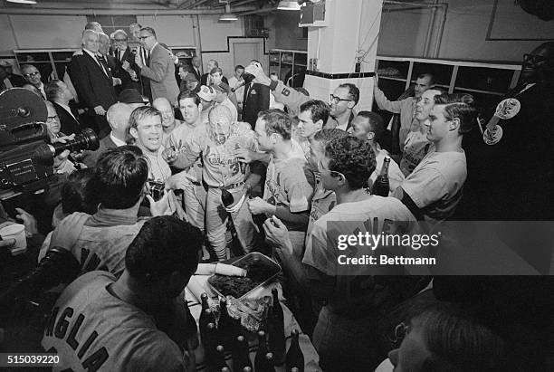 Orlando Cepeda of the Cardinals gets doused with champagne in the St. Louis dressing room after they won the 1967 World Series by defeating the...