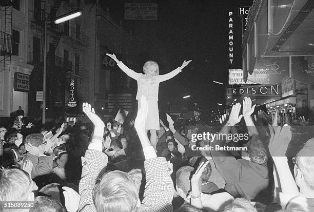 Treat for the Fans. New York: Frenzied fans "fight" to catch postcard size photos which glamour queen Marlene Dietrich tosses them from atop...