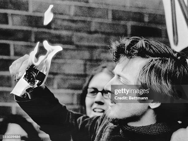 Goddard C. Graves, a former student of the University of Wisconsin, burns his selective service card in front of 100 women.