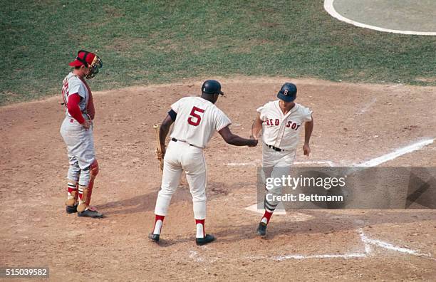 Carl Yastrzemski of the Boston Red Sox, is shown after batting in fourth inning of the 2nd World series game, as he crosses home plate after hitting...