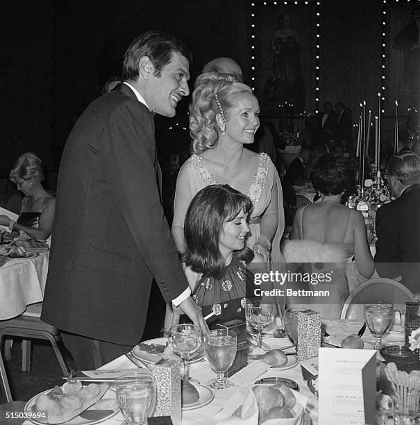 Actress Debbie Reynolds , president of the Thalians, a Hollywood charity organization, greets actor Omar Sharif and actress Anjanette Comer at the...