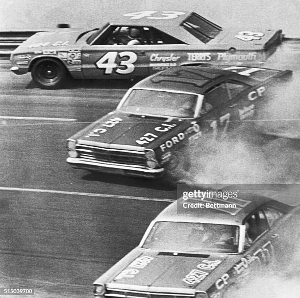 Top NASCAR driver Richard Petty hits the wall on the 4th turn here today midway in the National 500 Stock Car Race as Dave Pearson and Mario Andretti...