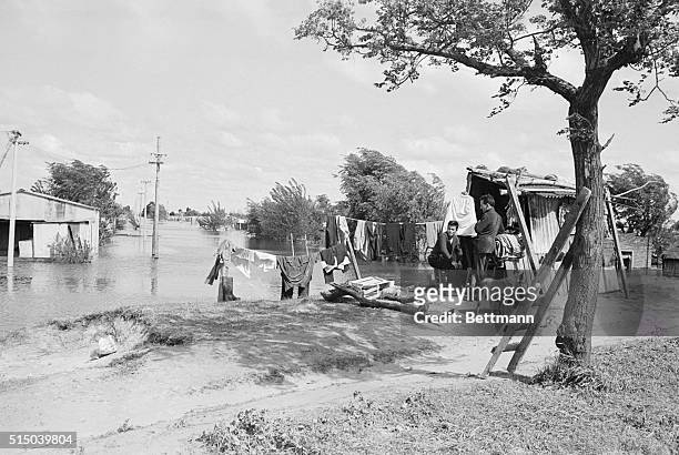 Waiting. Buenos Aires, Argentina: Two evacuees sit and wait for flood waters to subside before returning to their shanties in a suburb of Buenos...
