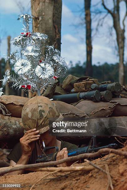 Steven McDonnell, of Santa Ana, California, in bunker on Hill 875, November 24th. A touch of home and the upcoming Christmas holiday is displayed on...