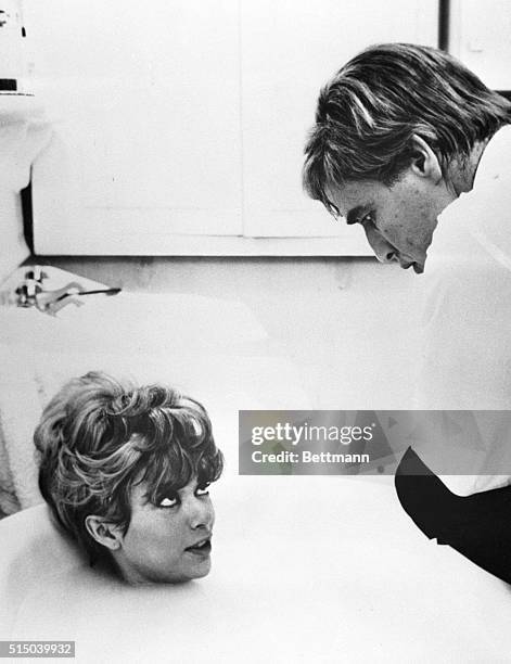 Lettouquet, France- Rita Moreno is in a tub while chatting with Marlon Brando during the filming of "The Night of the Following Day." Besides his...