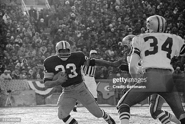 Travis Williams of the Packers, is scooting around end for short yardage, during a NFL title game against the Dallas Cowboys.