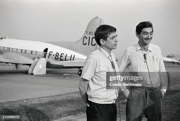 Daniel Berrigan of Cornell University and Dr. Howard Zinn of Boston University prepare here to leave Vientiane Airport en route to Hanoi to take...