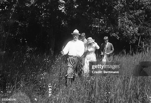 Former American President Theodore Roosevelt hikes with his wife, Edith, and two sons, Teddy Jr. And Kermit, along their Sagamore Hill estate...