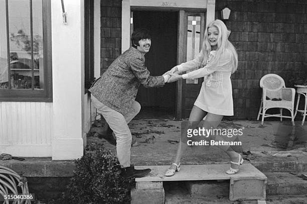 Needs arm-twisting...Reluctant Beatle Ringo Starr is offered some encouragement from Ewa Aulin who plays the role of the amorous Candy during...