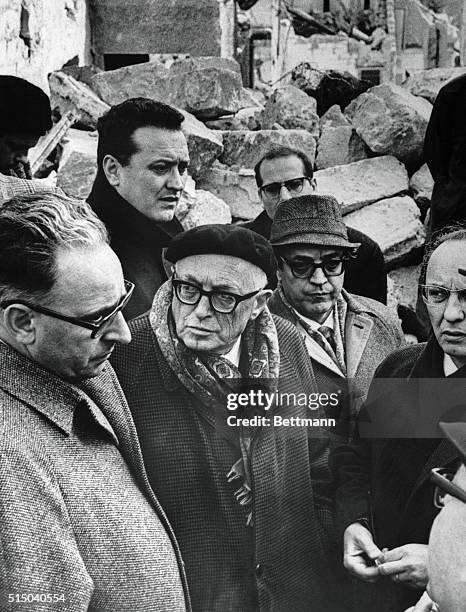 Italian Aldo Moro flanked by an unidentified man wearing glasses, talks to Gibellina residents January 19th during a tour of earthquake-racked...