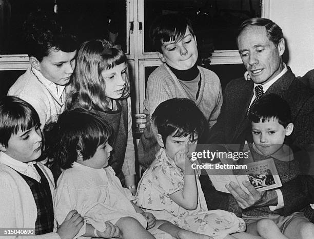 Famous American actor and film producer Mel Ferrer gets the attention, well almost,--of a group of children in the "Peter Pan" ward at Great Ormond...