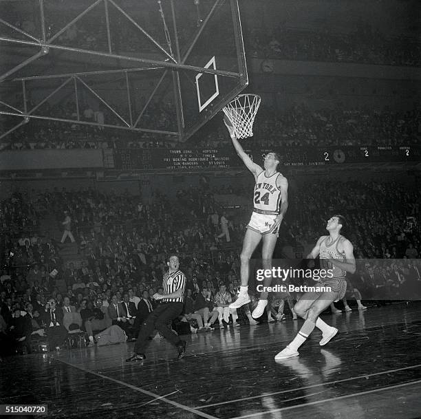 Bill Bradley of the New York Knicks is seen here scoring, as Dick Snyder of the St. Louis Hawks looks on hopelessly.