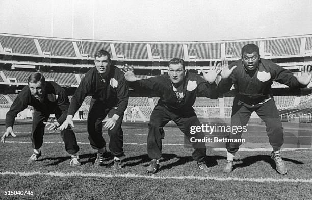 Photo shows the defensive wall of the AFL championship team, the Oakland Raiders, keeping in trim shape, at the Oakland Collegium where they are...