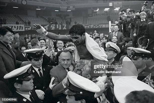 The world's new bantamweight champion, Lionel Rose of Australia, is victoriously carried out of the ring after he defeated Masahiko Harada of Japan...