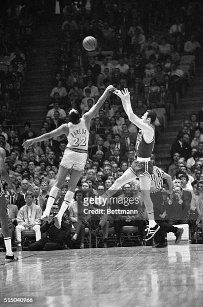 Los Angeles Lakers Elgin Baylor and Boston Celtics John Havliceck seem to do a ballet dance as they both go up high for a rebound early in the first...