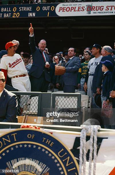 After having dropped the first ball, President Richard Nixon throws out a second and third ball to open the 1969 baseball season at the newly-named...