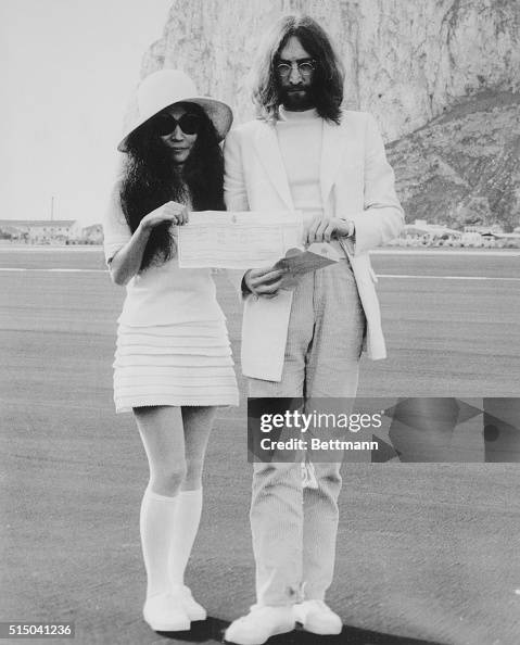 John Lennon and Yoko Ono Holding Marriage Certificate