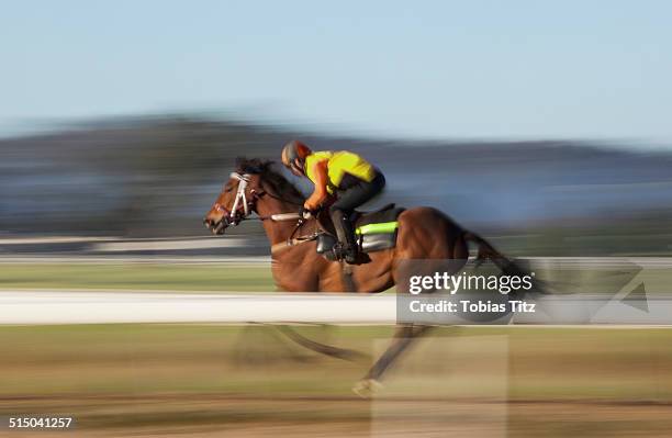 blurred motion of jockey riding horse - corrida de cavalos evento equestre - fotografias e filmes do acervo