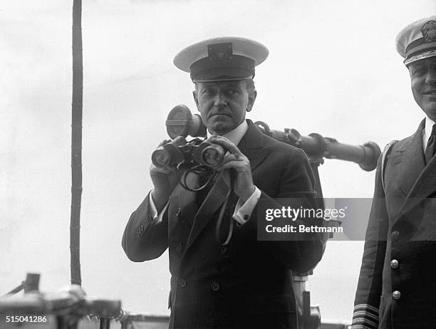 The President as a Yachtsman. Here is President Coolidge in his yachting outfit and with binoculars on the bridge of the Mayflower on his recent trip...