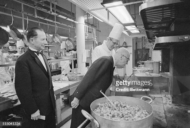 Charles Ritz son of Cesar Ritz, founder of the Ritz Hotel, Paris, inspects the kitchen while chef Robert Meyer and Maitre D'Hotel Robert Senechal...