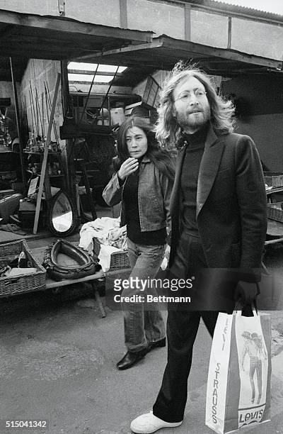 Musician John Lennon and his new bride Yoko Ono stroll the lanes of a flea market in Paris. Lennon and Yoko married March 20, 1969 in Gibraltar and...
