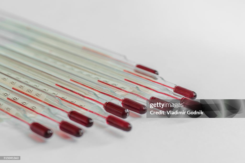 Group of thermometers over white background