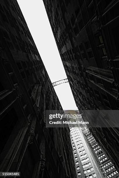 distant view of footbridge between two building facades in financial district, manhattan, usa - high key stock pictures, royalty-free photos & images