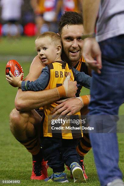 Jack Gunston of the Hawks celebrates the win with a family member as his dad Ray walks out during the NAB CHallenge AFL match between the Hawthorn...