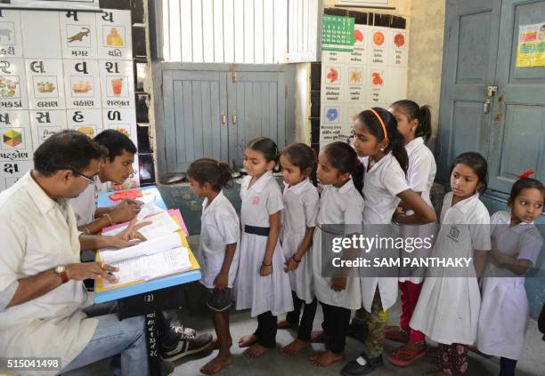 Indian schoolchildren are screened for kidney diseases at a school in Ahmedabad on March 11, 2016.