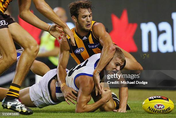 Angus Litherland of the Hawks tackles Jed Anderson of the Kangaroos during the NAB CHallenge AFL match between the Hawthorn Hawks and the North...