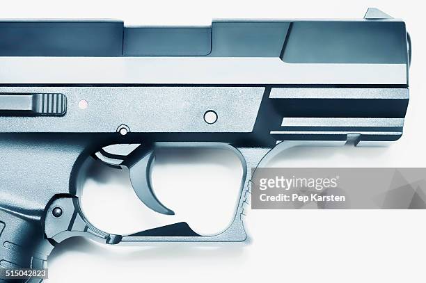 close-up of trigger and barrel of a handgun - trigger stockfoto's en -beelden