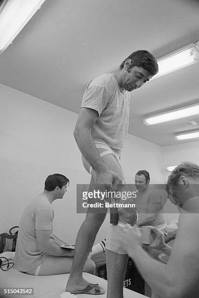 New York Jets quarterback Joe Namath has his famous knee taped prior to the Jets' Super Bowl engagement with the Baltimore Colts.