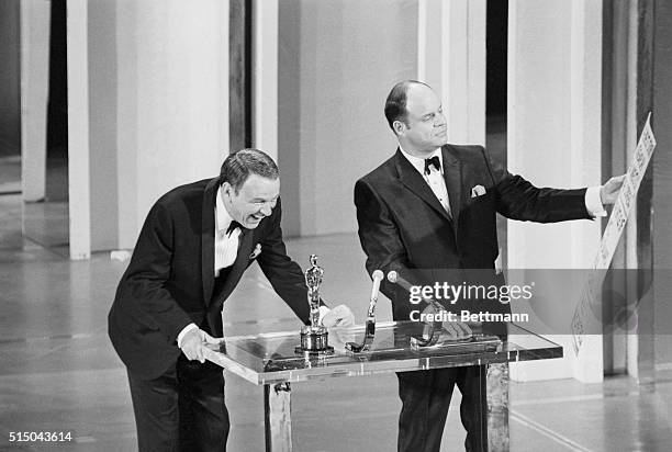 Frank Sinatra cracks up as comedian Don Rickles gives him a better look at the cue card during the 41st Annual Academy Awards Presentation.