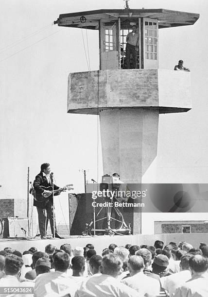 American country and western singer Johnny Cash performs 4/10 for about 800 inmates and guests at the Cummins Prison Farm, 10th April 1969. He...