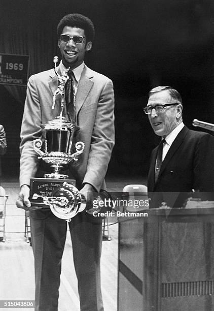 Superstar Lew Alcindor has his hands full as he holds two of the many awards he was given at the UCLA Basketball Awards Ceremony at the school's...